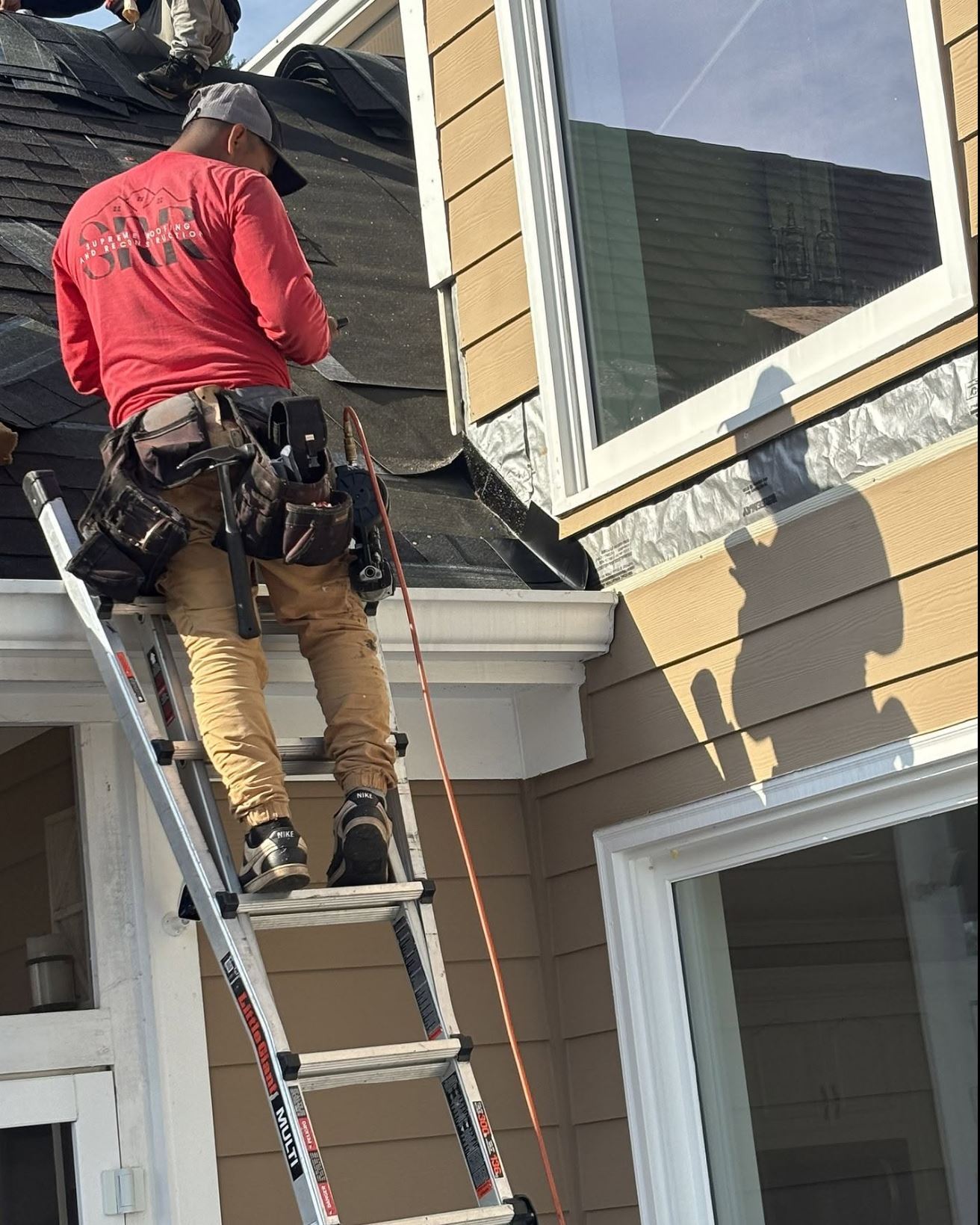 Supreme Roofing crew installing gutters in Paulding County, GA — seamless gutter installation completed in one day